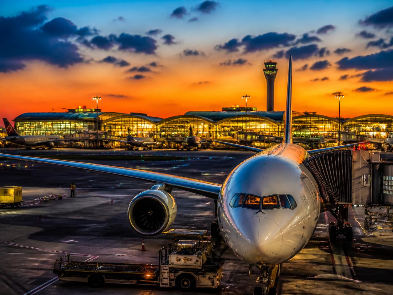 International aircraft at an airport terminal at night
